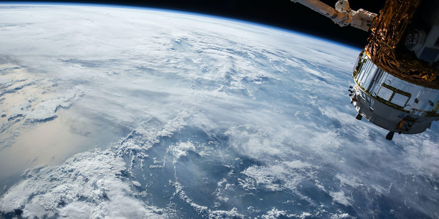 close up view of the earth and a satellite from outer space